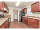 A kitchen with cherry cabinets, laminate countertops, an electric range and a stainless steel refrigerator at 208 Lakewood Ave, Charlotte, NC 28208