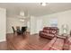 Open-concept living room features wood floors, natural lighting and flows into the dining area at 208 Lakewood Ave, Charlotte, NC 28208