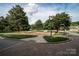 Photo of a nicely landscaped neighborhood corner with a streetlamp and benches at 211 Harbour Place Dr, Davidson, NC 28036