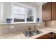 Kitchen features double sink and tile backsplash at 211 Harbour Place Dr, Davidson, NC 28036