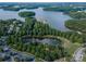 Aerial view of a lakefront community with lush greenery, showcasing a peaceful lakeside setting at 211 Harbour Place Dr, Davidson, NC 28036