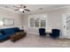 Living room with blue sofa, armchairs and a large window at 211 Harbour Place Dr, Davidson, NC 28036