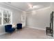 Bright living room with blue sofa and two velvet armchairs at 211 Harbour Place Dr, Davidson, NC 28036