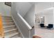 Carpeted staircase with neutral walls and a view of a sitting area at 211 Harbour Place Dr, Davidson, NC 28036