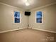 Well-lit bedroom featuring two windows and carpeted floor at 235 Linda St, Salisbury, NC 28146