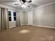 Spacious bedroom with carpeted floor, ceiling fan, and window with curtains at 235 Linda St, Salisbury, NC 28146