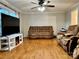 Living room with hardwood floors, fireplace, and large TV at 235 Linda St, Salisbury, NC 28146