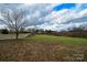 Landscaped backyard with a walking path and trees at 2610 Lucy Short Cut Rd, Marshville, NC 28103