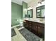 Double vanity bathroom with dark brown cabinets and green walls at 2610 Lucy Short Cut Rd, Marshville, NC 28103