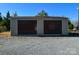 Tan metal detached garage with two roll-up doors at 2610 Lucy Short Cut Rd, Marshville, NC 28103