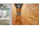 Basement hallway with wood walls and a full-length mirror at 277 Archie Mountain Ln, Taylorsville, NC 28681