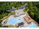 An aerial view shows a community pool with a slide and playground near clubhouse with ample parking at 3020 Sewee Ln, Waxhaw, NC 28173