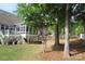 Spacious backyard with a fire pit, deck, screened-in porch, and mature trees offering privacy at 3020 Sewee Ln, Waxhaw, NC 28173