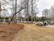 Landscaped backyard with firepit and patio area at 3020 Sewee Ln, Waxhaw, NC 28173