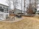 Backyard patio with table and chairs, fire pit, and grass at 3020 Sewee Ln, Waxhaw, NC 28173