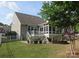 Expansive backyard with a deck, screened in porch and a stone fire pit, ideal for outdoor entertaining at 3020 Sewee Ln, Waxhaw, NC 28173