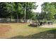 Lush backyard featuring a stone fire pit, perfect for relaxing and enjoying the outdoors at 3020 Sewee Ln, Waxhaw, NC 28173