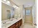 Well-lit bathroom with a dual sink vanity, a large mirror, and good lighting at 3020 Sewee Ln, Waxhaw, NC 28173