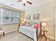 Comfortable bedroom with a daybed, light colored walls, wood-look flooring, and a large window for natural light at 3020 Sewee Ln, Waxhaw, NC 28173