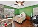 Green bedroom with a ceiling fan, large windows, and built-in workspace at 3020 Sewee Ln, Waxhaw, NC 28173