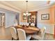 Well-lit dining room with a large table, decorative chandelier, and built-in cabinet at 3020 Sewee Ln, Waxhaw, NC 28173