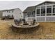 Cozy firepit surrounded by stone seating wall in backyard at 3020 Sewee Ln, Waxhaw, NC 28173