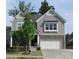 Inviting home with stone accents, a two-car garage, and a charming front porch with manicured landscaping at 3020 Sewee Ln, Waxhaw, NC 28173