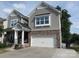 Charming two-story home boasts stone accents, a two-car garage, and a quaint front porch at 3020 Sewee Ln, Waxhaw, NC 28173