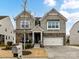 Charming two-story home with a two-car garage, stone accents, and a well-maintained front yard at 3020 Sewee Ln, Waxhaw, NC 28173