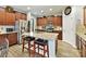 Well-lit kitchen features wood cabinets, stainless appliances and a large island with granite countertops at 3020 Sewee Ln, Waxhaw, NC 28173