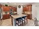 Well-lit kitchen features wood cabinets, stainless appliances and a large island with granite countertops at 3020 Sewee Ln, Waxhaw, NC 28173