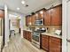 Well-equipped kitchen featuring stainless appliances and wood cabinets with light countertops and flooring at 3020 Sewee Ln, Waxhaw, NC 28173