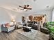 Open concept living room with a view into the kitchen, featuring modern furniture and decor at 3020 Sewee Ln, Waxhaw, NC 28173