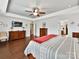 Bright main bedroom with hardwood floors, neutral walls, tray ceiling, and access to walk-in closet at 3020 Sewee Ln, Waxhaw, NC 28173