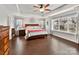 Bright main bedroom with a ceiling fan, large windows, and hardwood floors at 3020 Sewee Ln, Waxhaw, NC 28173