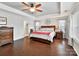 Main bedroom with hardwood floors, large windows and ceiling fan at 3020 Sewee Ln, Waxhaw, NC 28173