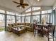 Bright sunroom with large windows, a vaulted ceiling, a ceiling fan, and a dining area for relaxation and entertainment at 3020 Sewee Ln, Waxhaw, NC 28173