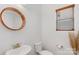 Stylish powder room with a round mirror and modern vanity at 3126 Elmwood Dr, Monroe, NC 28110