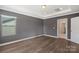 Simple bedroom with wood floors and access to bathroom at 3126 Elmwood Dr, Monroe, NC 28110