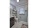 Bathroom with dark vanity, white toilet and marble floor at 4105 South Fork Ave, Hickory, NC 28602