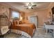 Bedroom with dresser, ceiling fan and orange bedding at 4105 South Fork Ave, Hickory, NC 28602