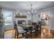 Bright dining room features a rustic table, chandelier, and view into the kitchen at 4105 South Fork Ave, Hickory, NC 28602