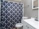 Clean bathroom with white vanity, shower, and patterned curtain at 4405 Tillman Rd, Charlotte, NC 28208