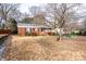 Brick home with a tree-lined yard and driveway at 4405 Tillman Rd, Charlotte, NC 28208