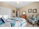 Bedroom with a ceiling fan, a comfortable bed, and an antique chair at 5021 Redwood Grove Trl # 86, Lancaster, SC 29720