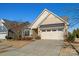 Tan colored house with a two car garage and landscaping at 5021 Redwood Grove Trl # 86, Lancaster, SC 29720