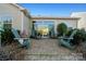 Relaxing patio with brick pavers and green chairs at 5021 Redwood Grove Trl # 86, Lancaster, SC 29720