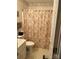 Bathroom with floral shower curtain, toilet, and vanity at 506 Birmingham Ct, Rock Hill, SC 29732