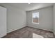 Well-lit bedroom with neutral carpeting and a window at 638 Sagecroft Ln, Indian Trail, NC 28079