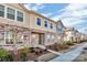 Row of townhomes showcasing similar design, landscaping, and street view at 638 Sagecroft Ln, Indian Trail, NC 28079